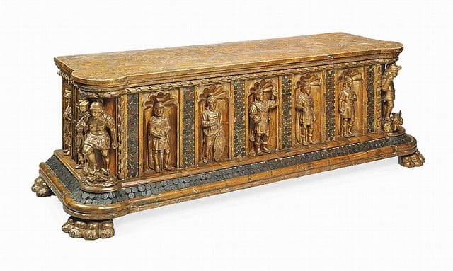 Ornate antique wooden chest with carved figures and intricate details.